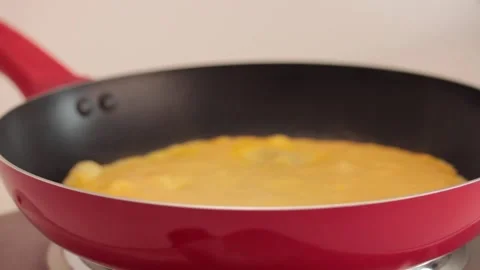Preparing scrambled eggs in a cooking pan Stock Footage 133814801