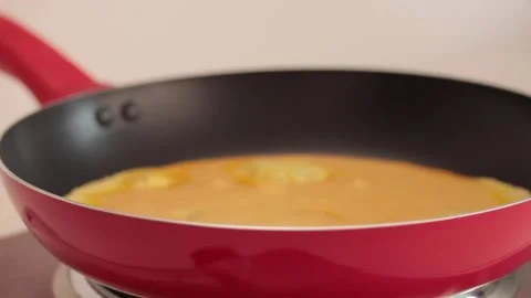 Preparing scrambled eggs in a cooking pan Stock Footage 133814810