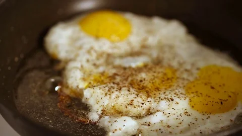 Preparing scrambled eggs on hot frying pan Video stock 72202799
