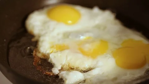 Preparing scrambled eggs on hot frying pan Video stock 72213239