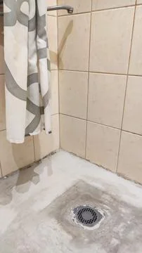 Preparing a shower area base during bathroom renovation, with cement mortar.. Stock Photos