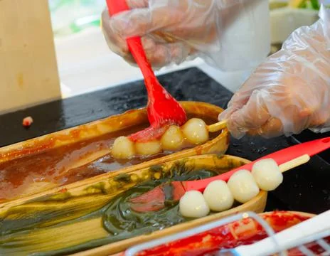 Preparing Skewered Rice Cake Balls with Toppings Stock Photos