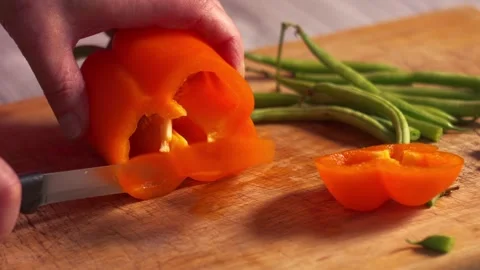 Preparing sliced orange pepper vegetables Video stock 336953785