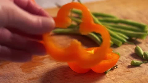 Preparing sliced orange pepper vegetables Video stock 336954741