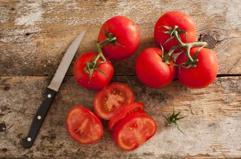 Preparing sliced ripe red tomatoes Stock Photos