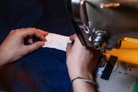 Preparing to sow white patch on jeans Stock Photos