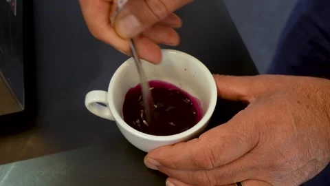 Preparing a Specialty Ube Latte Drink in a Ceramic Cup Vídeo Stock 347932012