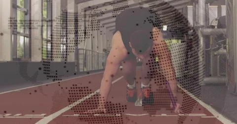 Preparing sprinter in black top and orange shoes on track, starting blocks and Stock Photos