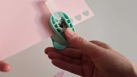 Preparing for St. Valentines Day, making heart shaped paper confetti Stock Footage 326243390