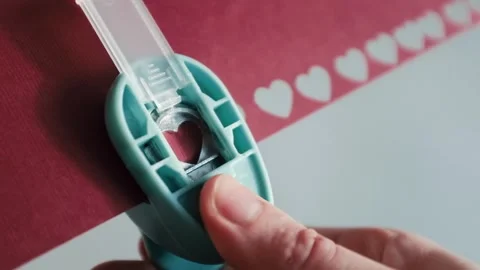 Preparing for St. Valentines Day, making heart shaped paper confetti Stock Footage 326243432