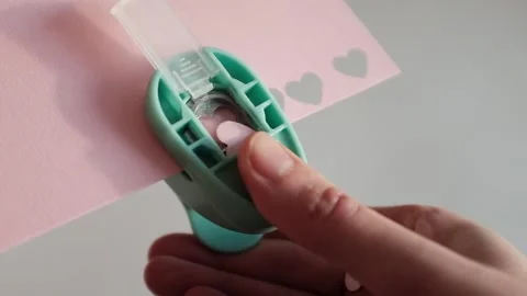 Preparing for St. Valentines Day, making heart shaped paper confetti Stock Footage 326243478