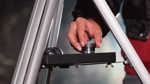 Preparing for star observation with precise equipment adjustments. Meticulous Stock Footage 334061169