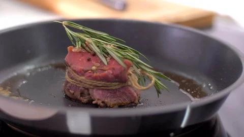 Preparing steak filet mignon with butter and rosemary Stock Footage 106923795