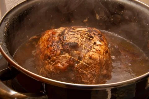 Preparing a stew with pork roll Stock Photos