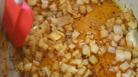 Preparing a stew of roasted ribs, frying onion and garlic Stock Footage 219720611