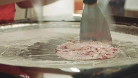 Preparing stir-fried ice cream rolls with strawberry at freeze pan. Rolled ic Stock Footage 111264576