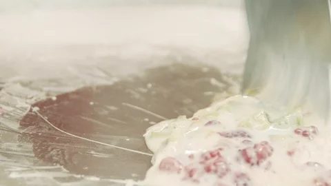 Preparing stir-fried ice cream rolls with raspberry and kiwi at freeze pan. R Stock Footage 111264747