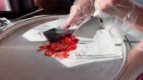 Preparing stir-fried ice cream rolls strawberry at freeze pan. Homemade sweet Stock Footage 149336045