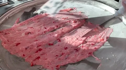 Preparing stir-fried ice cream rolls strawberry at freeze pan. Homemade sweet Stock Footage 149680813