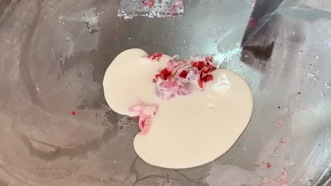 Preparing stir-fried ice cream rolls strawberry at freeze pan. Homemade sweet Stock Footage 149684857