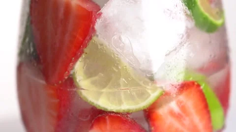 Preparing strawberry and lime lemonade with ice cubes. Mojito cocktail, fiz.. Stock Footage 275882246