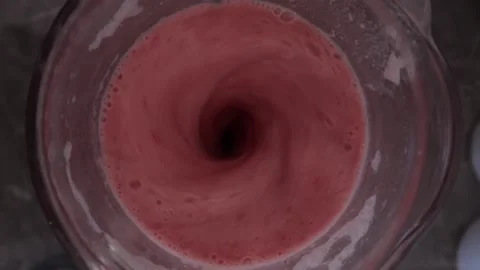 Preparing a strawberry smoothie or strawberry juice. Healthy food concept. Stock Footage 220735557