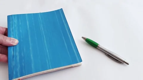 Preparing for Success: Blue Notebook, Green Pen New Ideas Await 스톡 동영상 313043511