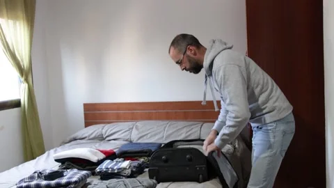 Preparing suitcase for travel at home Stock Footage 237372813