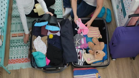 Preparing for summer vacation by packing suitcase Stock Footage 297247890