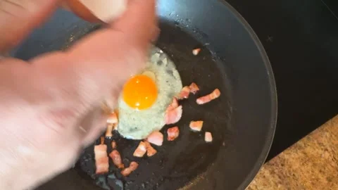 Preparing Sunny-Side-Up Eggs with Bacon Stock Footage 278168121