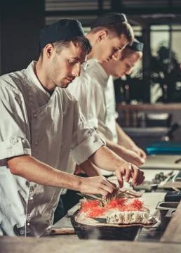 Preparing sushi set in restaurant kitchen Stock Photos