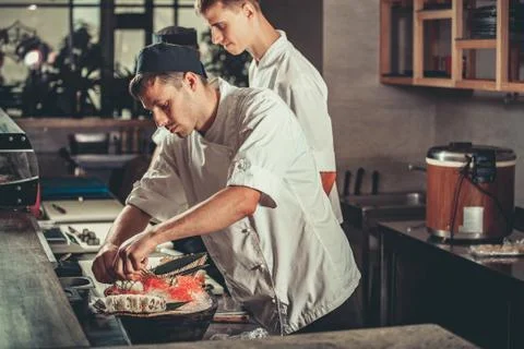 Preparing sushi set in restaurant kitchen 스톡 사진