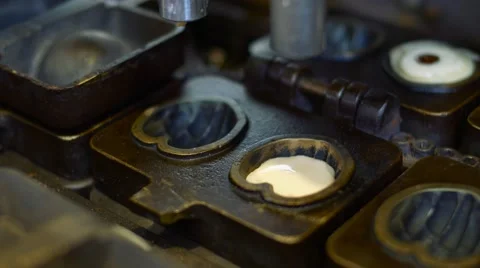 Preparing sweet cakes with a small machine to attract tourists at a local market Stock Footage 68925464