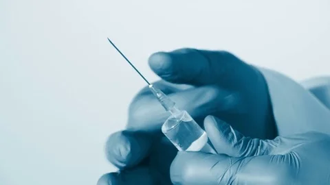 Preparing syringe for giving injection Stock Footage 70748418