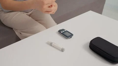 Preparing to test blood sugar level with a glucometer at home Stock Footage 346703415