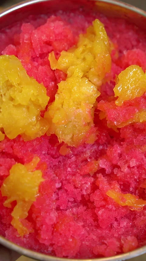 Preparing Thai dessert: shaved ice topped with red syrup and candied pineapple i Stock-Footage 341931252