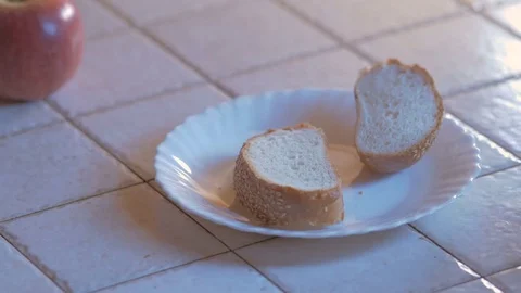 Preparing toast with butter and jam woman hand rubs butter on a toasted piece of Stock Footage 70685308
