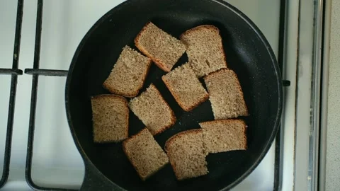 Preparing toasted rye bread slices on a frying pan Stock Footage 337830416