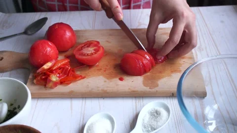 Preparing tomato sauce at home. Cut tomatoes in small pieces  Stock Footage 153104789