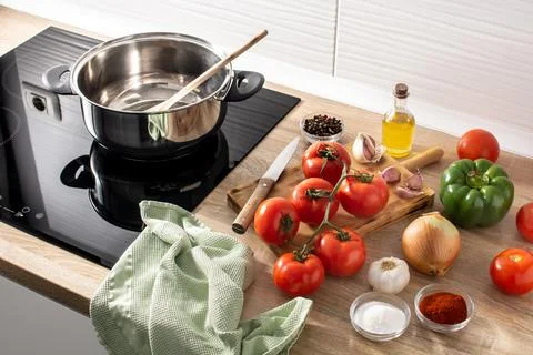Preparing tomato sauce in the kitchen. Ingredients on the kitchen counter Stock Photos