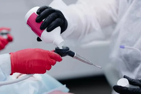 Preparing tools for brushing teeth by dentist in dental office close up Stock Photos