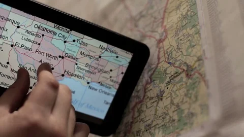 Preparing for the tourist trip using a the tablet and map Video stock 74377658