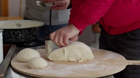 Preparing a traditional dish outdoors in a snowy setting. Stock Footage 310016352