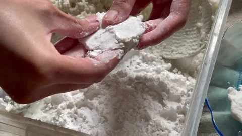 Preparing traditional fried tapioca flour snack known as cireng manually by hand Stock Footage 327233435