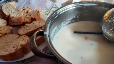 Preparing Traditional Spanish Torrijas Soaking Bread in Milk and Cinnamon 스톡 동영상 332440792