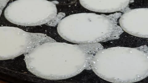 Preparing traditional Thai coconut pudding on hot griddle. Stock Footage 304406422
