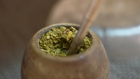 Preparing traditional yerba mate drink in gourd Stock Footage 328402605