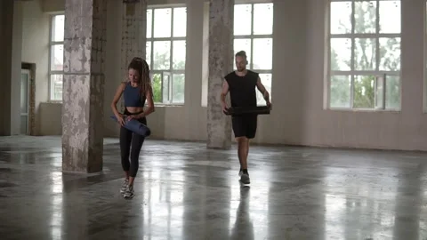 Preparing for training in empty studio with panoramic windows. Young woman with Video stock 138987351