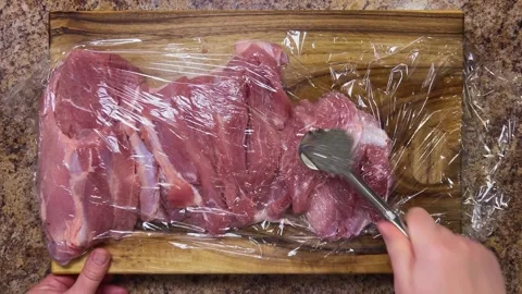 Preparing the turkey thigh for the roulade.  Video stock 328294451