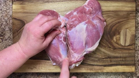 Preparing the turkey thigh for the roulade.  Stock-Footage 328601367